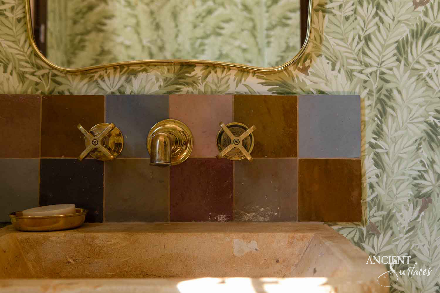 Reclaimed antique limestone bench sink from Ancient Surfaces, catalogued as SNK 187, on scrolled corbel legs, photographed against black with dealer measurements of 42.5 inches wide